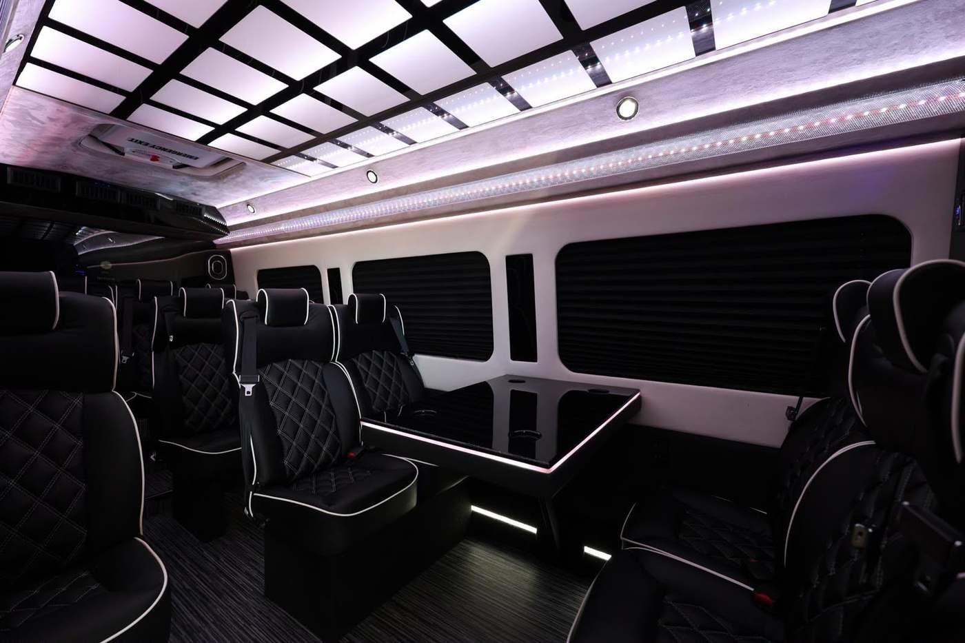 Mercedes-Benz Sprinter interior with leather captain's chairs and a conference table